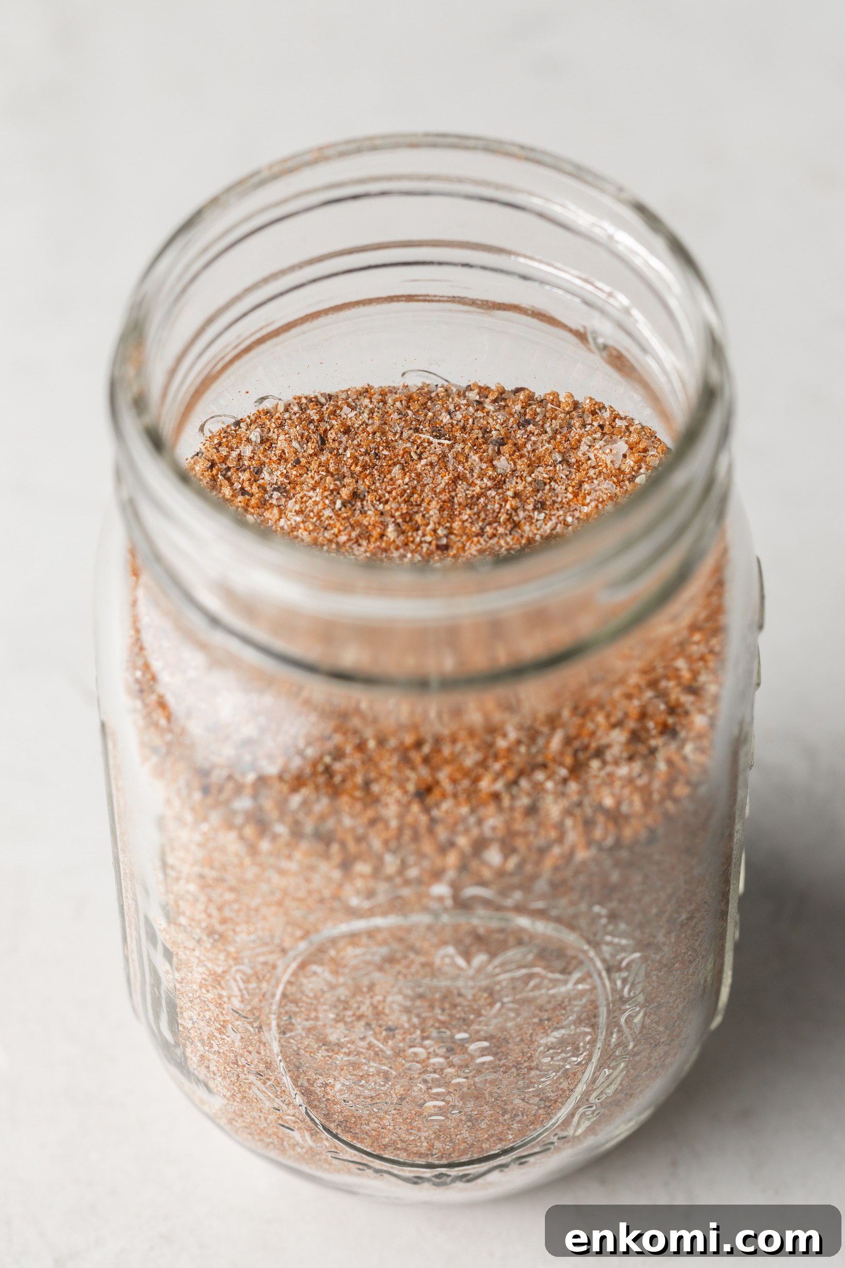 Homemade BBQ Rub Recipe for Tender, Flavorful Grilling 2 Homemade BBQ seasoning in a glass mason jar.