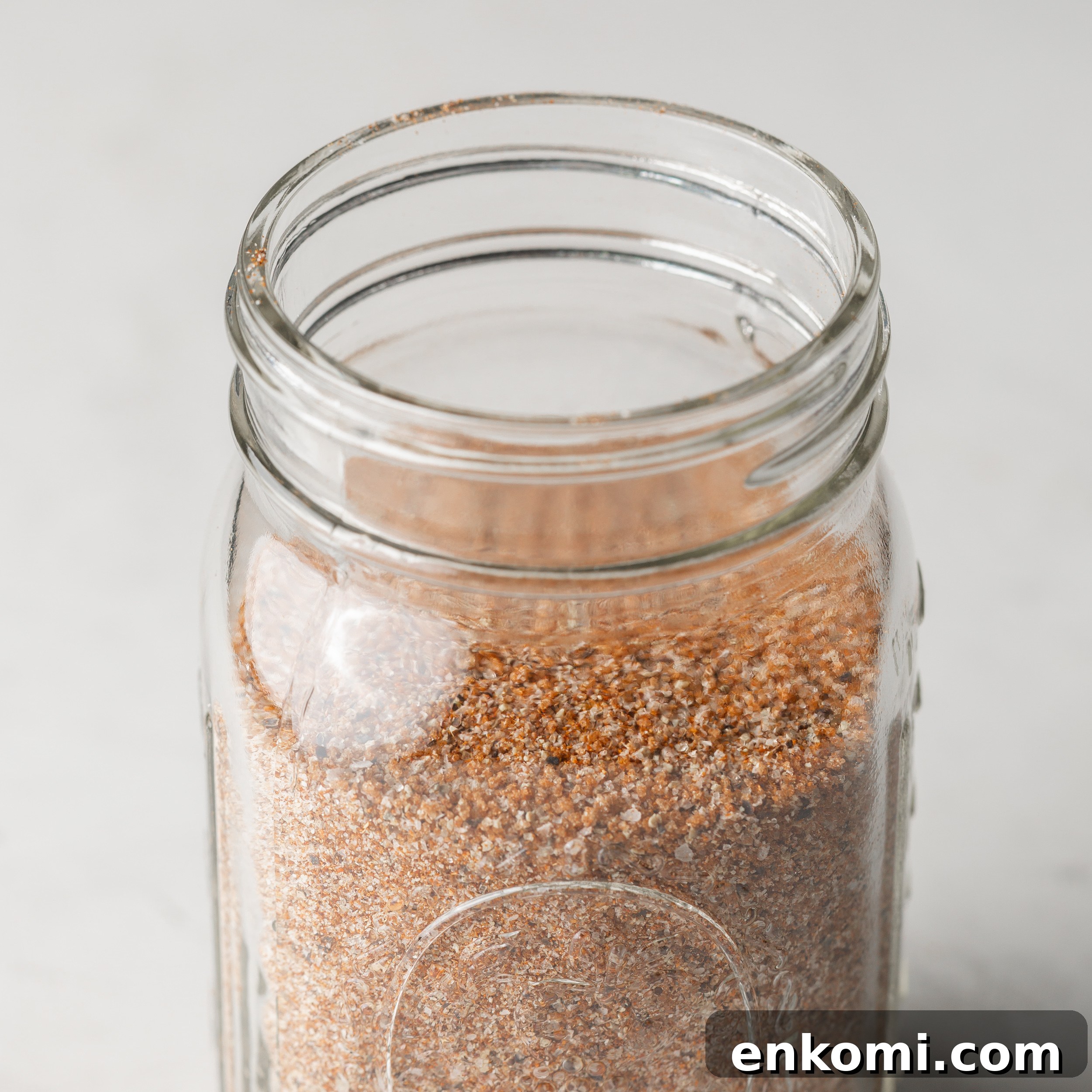 Homemade BBQ Rub Recipe for Tender, Flavorful Grilling 7 BBQ seasoning in a glass mason jar.