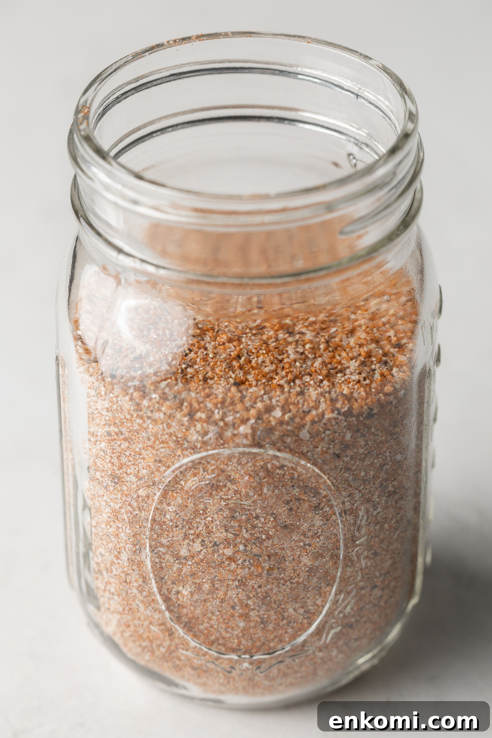 Homemade BBQ Rub Recipe for Tender, Flavorful Grilling 8 A closeup of BBQ seasoning in a glass mason jar.
