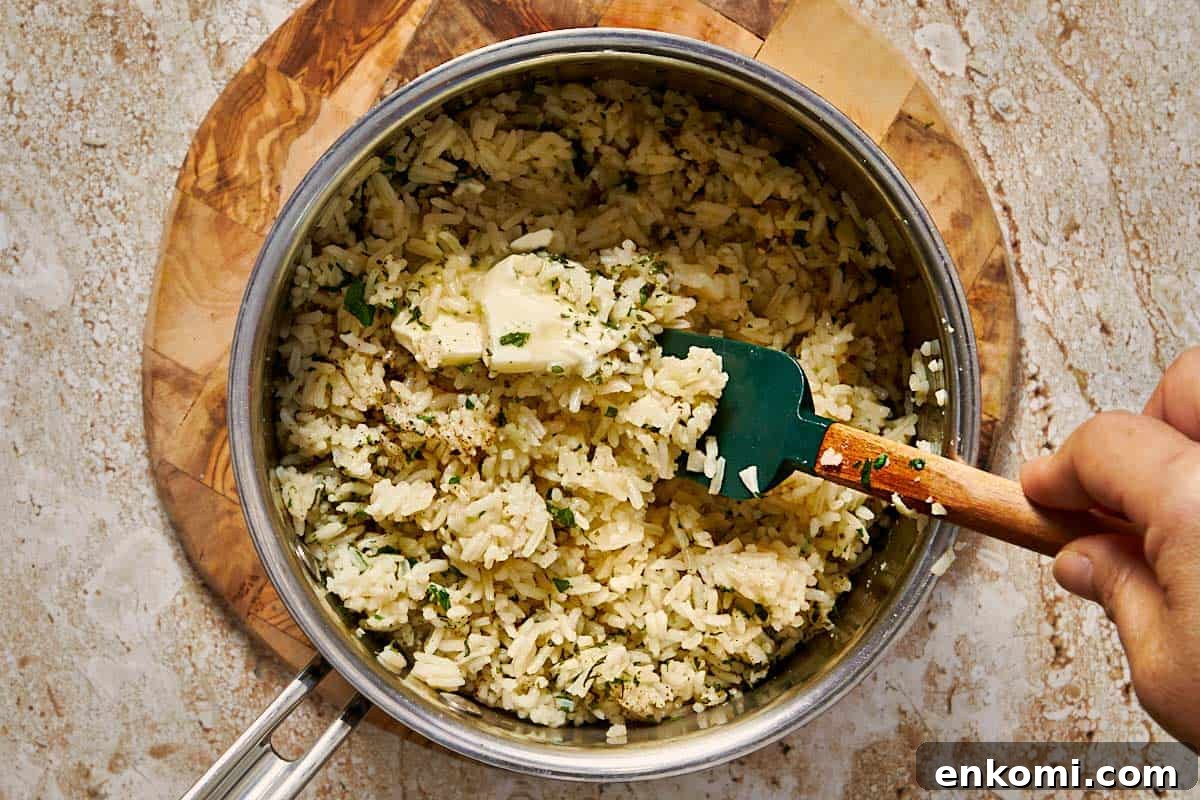 Garlic Butter Rice Recipe: Fluffy, Flavorful Side Dish 11 rice fully cooked in a pot with garlic butter and parsley