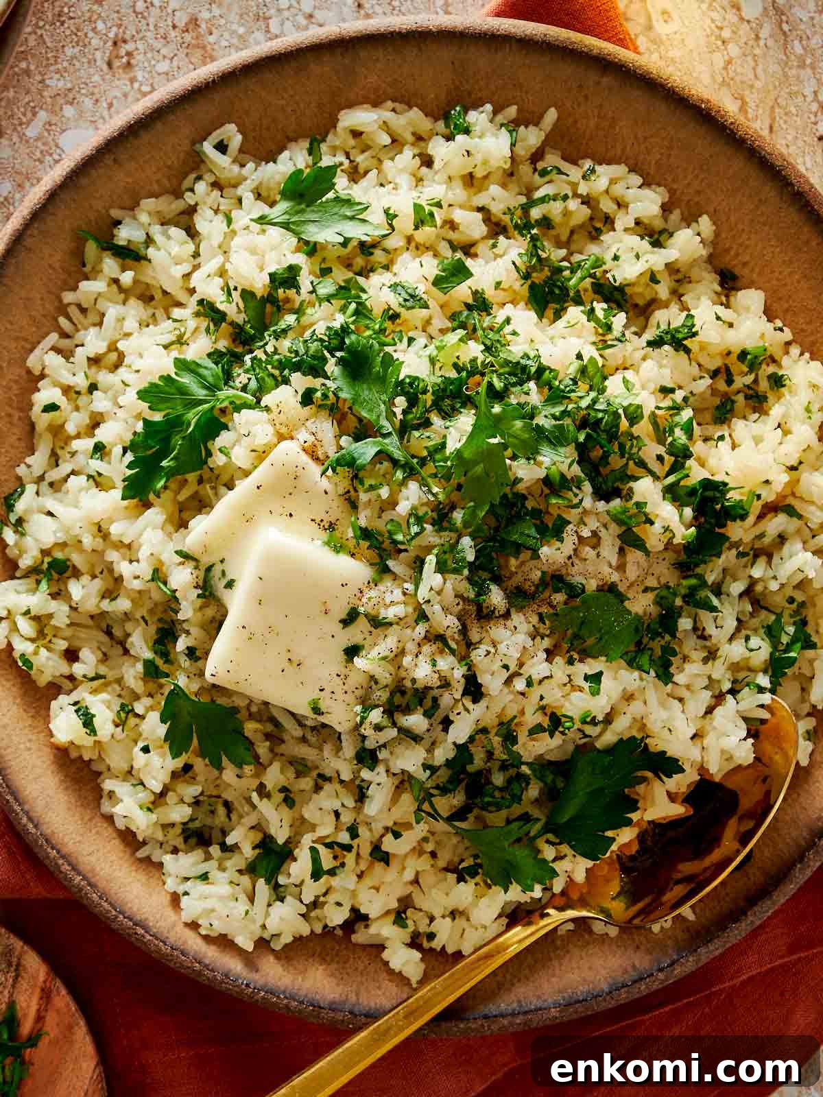 Garlic Butter Rice Recipe: Fluffy, Flavorful Side Dish 12 close up top down shot of garlic butter rice in a bowl with melting butter