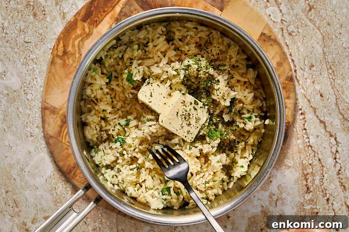 Garlic Butter Rice Recipe: Fluffy, Flavorful Side Dish 10 rice being cooked in a pot with garlic butter and parsley