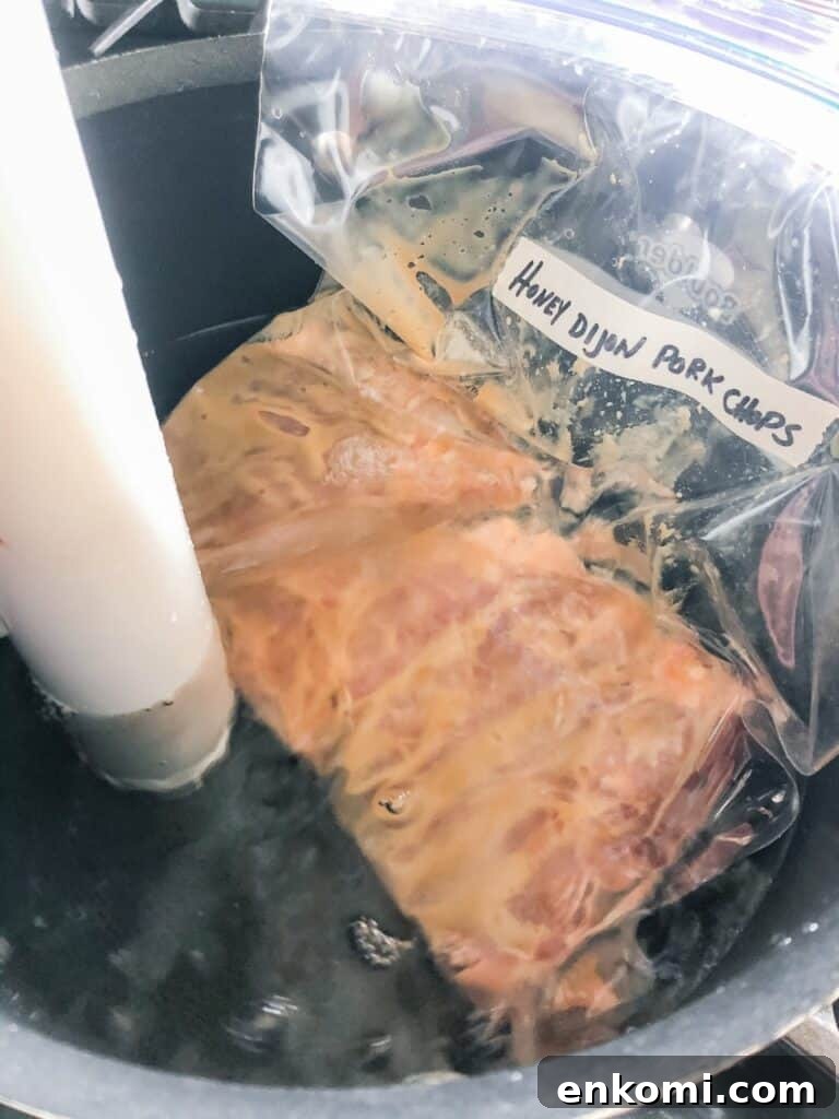 Honey Dijon Pork Chops: Sous Vide, Grill, or Oven Roast 3 Honey dijon pork chops in a water bath.