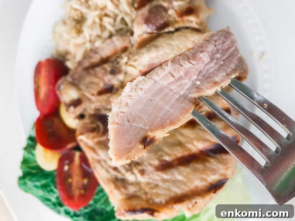 Honey Dijon Pork Chops: Sous Vide, Grill, or Oven Roast 4 A piece of cooked pork on a fork.