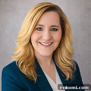 a professional portrait of zona house wearing a teal blazer.