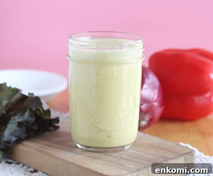 Creamy salad dressing in a small mason jar.