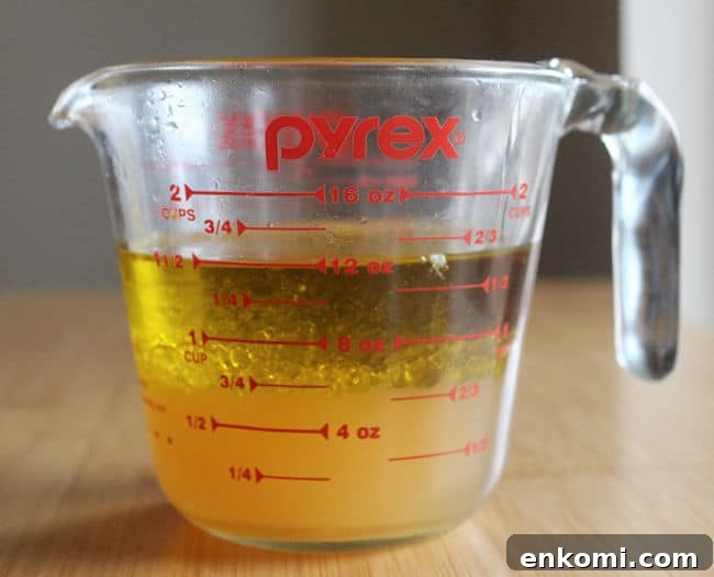 Glass pitcher filled with oil and vinegar.