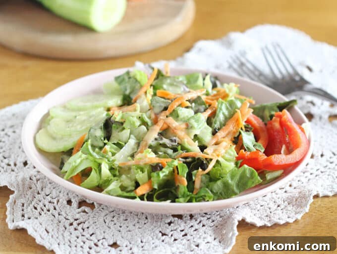 Salad and raw vegetables in a white bowl.