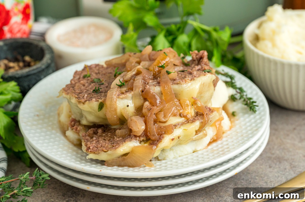 French Onion Meatloaf with Caramelized Onions and Gruyère 7 Sliced slow cooker french onion meatloaf on a plate.