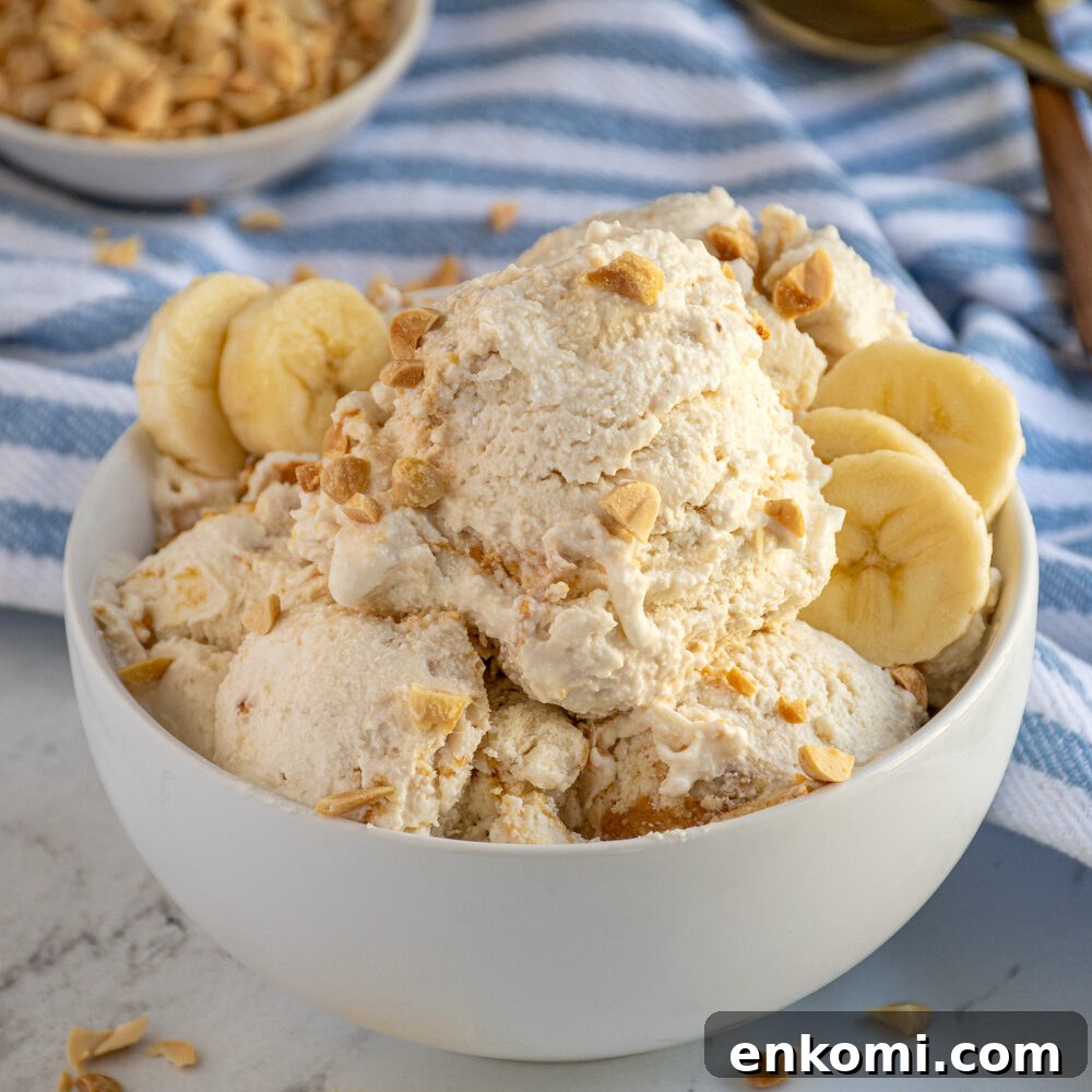 Cottage Cheese & Apple Breakfast Bowls with Granola and Honey 4 A bowl filled with cottage cheese ice cream garnished with crushed peanuts and banana slices.