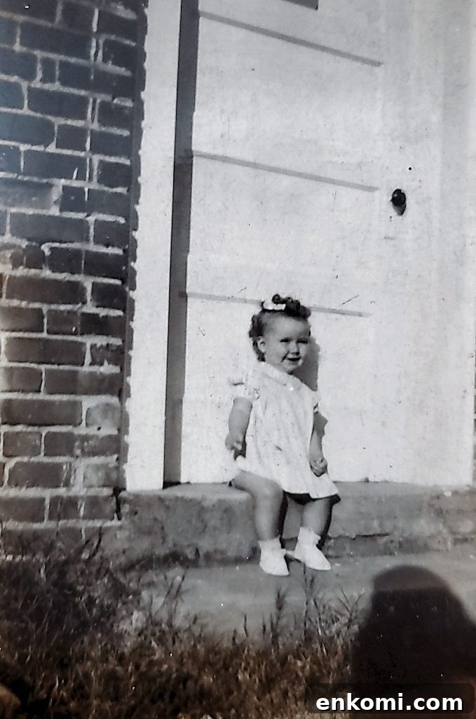Little girl Doris Carr sitting on house steps