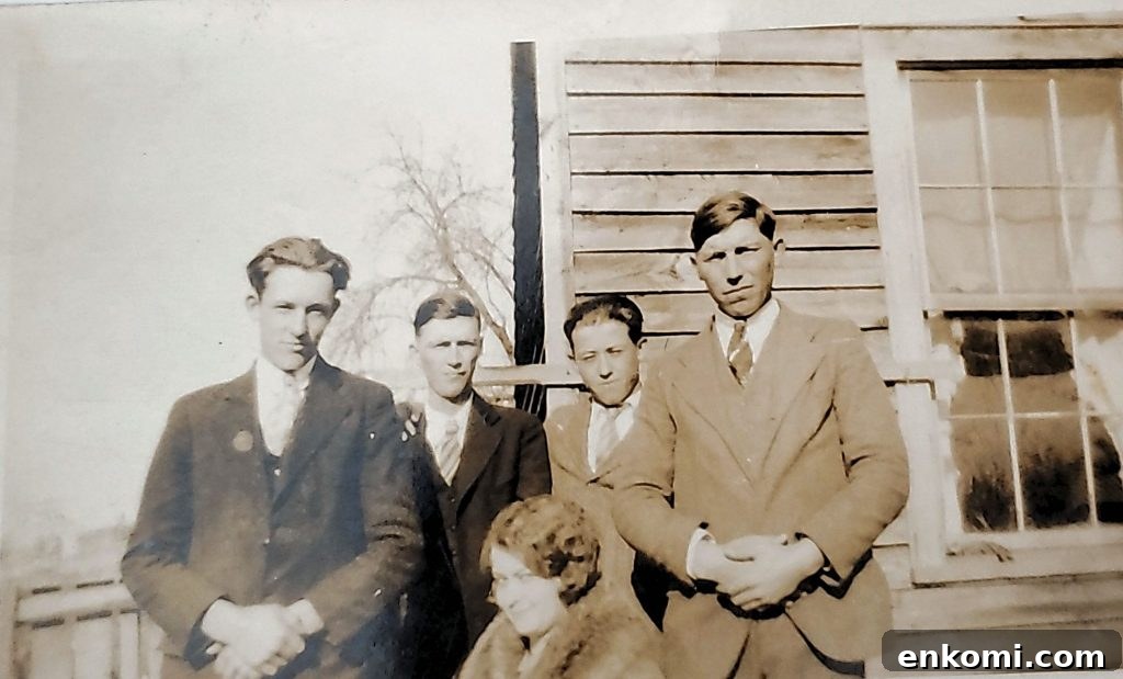 Old family photos of Haley cousins standing in front of wood sided house.