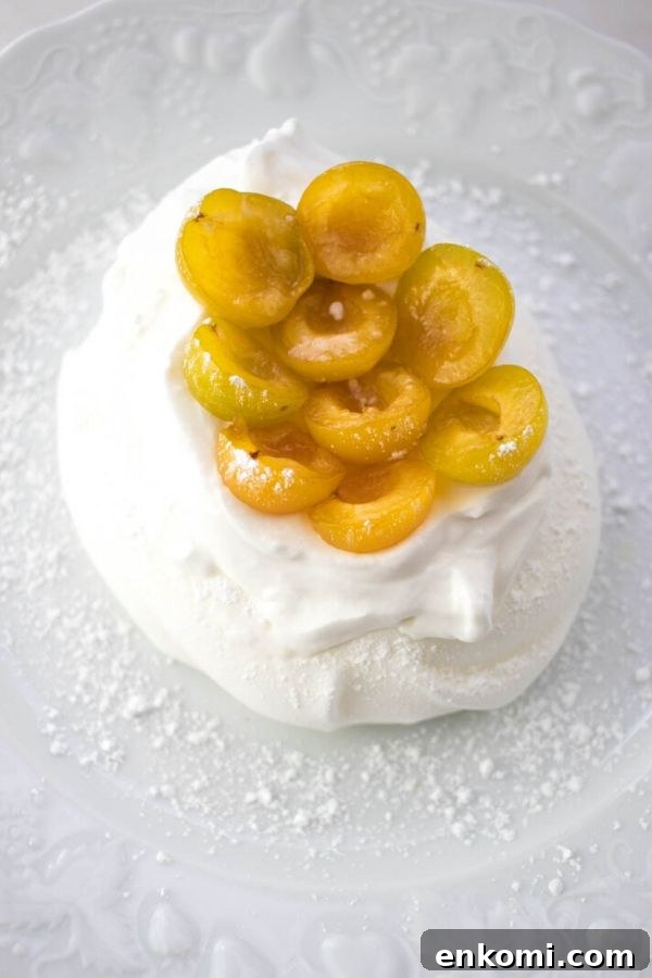 Schaum Torte topped with yellow mirabelle prunes
