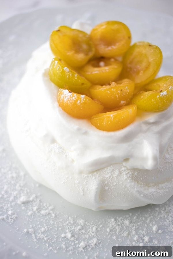 Schaum Torte topped with yellow mirabelle prunes