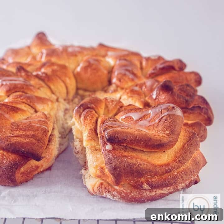 A square picture of part of a cinnamon star bread layered, with condensed milk drizzled on top.