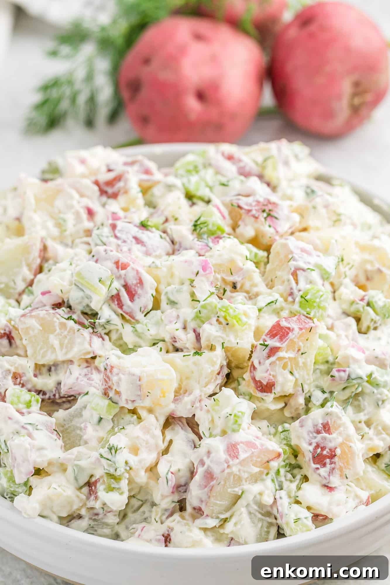 Creamy Dill Potato Salad with Fresh Herbs & Lemon Zest 2 Dill potato salad in a large white bowl.