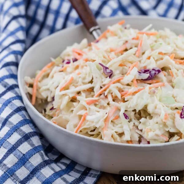 Creamy Dill Potato Salad with Fresh Herbs & Lemon Zest 13 Creamy coleslaw in a bowl with a spoon.