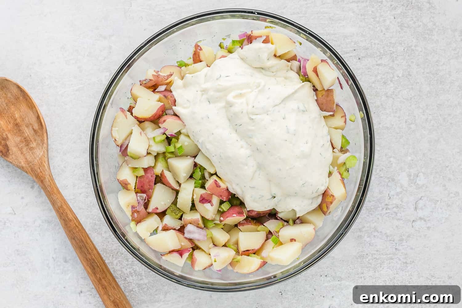 Creamy Dill Potato Salad with Fresh Herbs & Lemon Zest 8 Dressing on top of potato salad ingredients, not yet mixed.