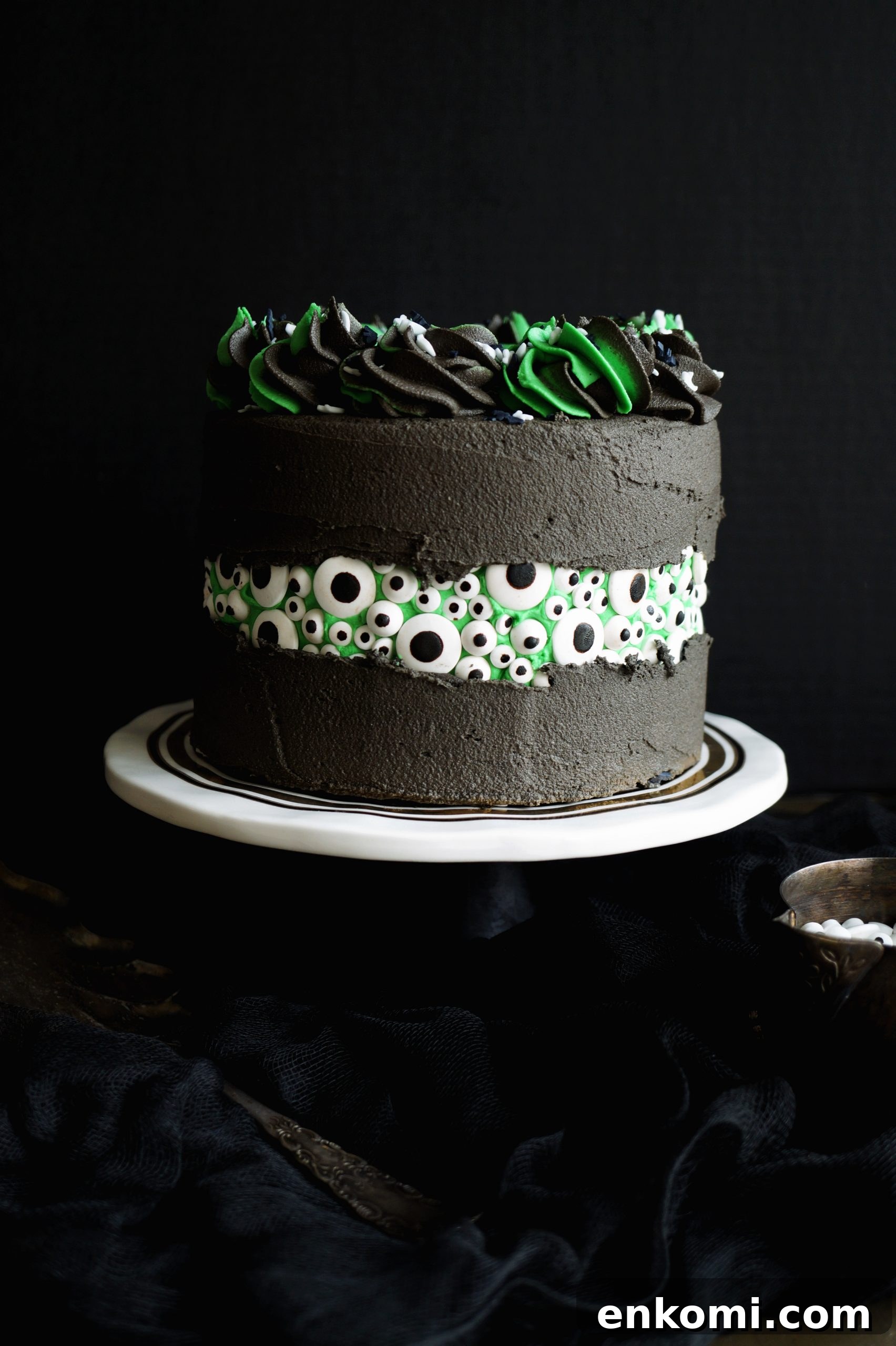 Vegan Green Velvet Eyeball Fault Line Cake Recipe 2 black cake with a peekaboo section of candy eyeballs