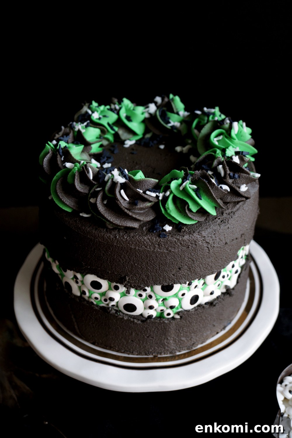Vegan Green Velvet Eyeball Fault Line Cake Recipe 4 angled shot of black cake with candy eyeballs
