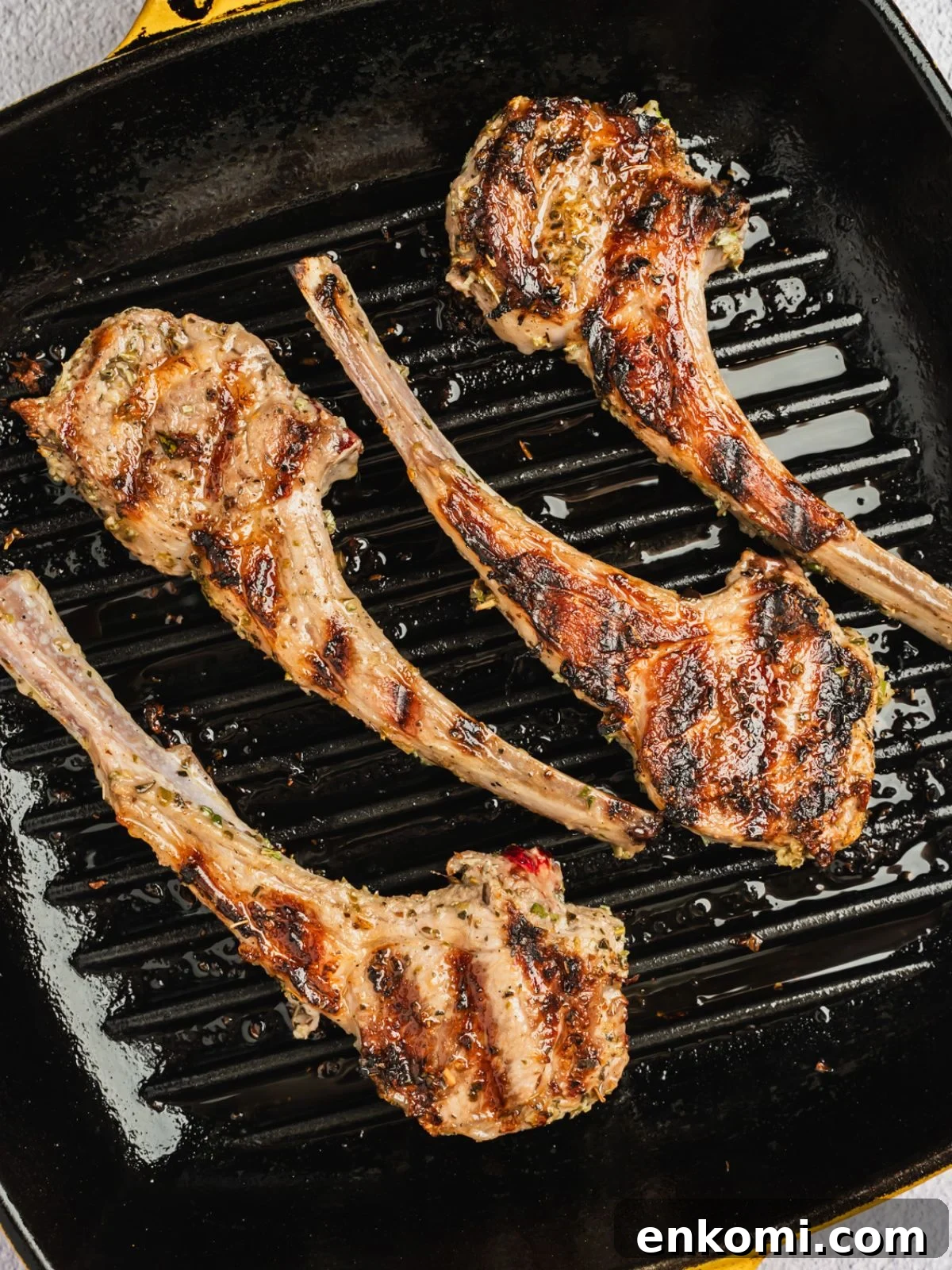 Grilled or Pan-Seared Marinated Greek Lamb Chops 7 Chops grilling on a grill pan.