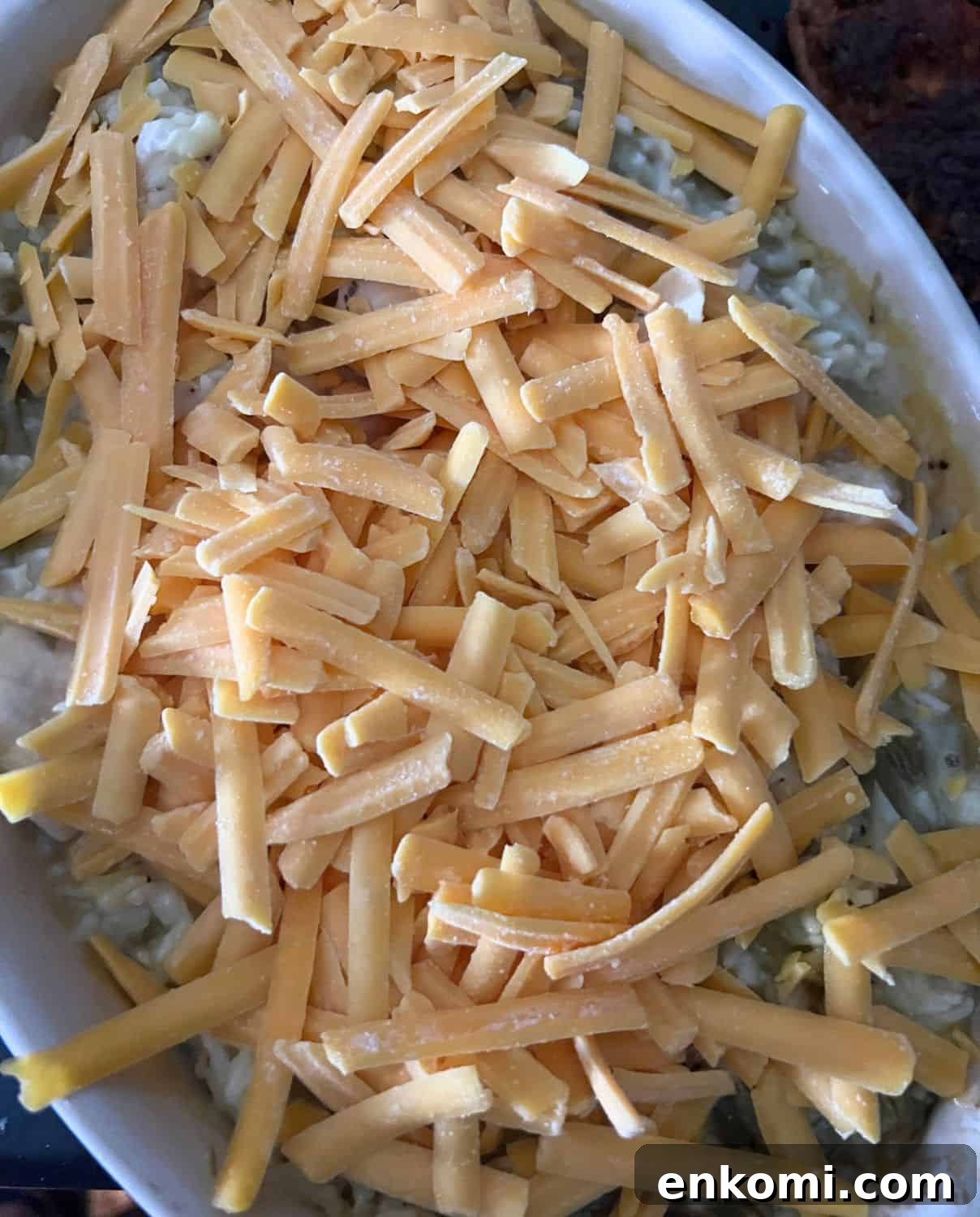 Cheesy Baked Chicken and Green Beans with Garlic Breadcrumbs 6 Casserole covered with cheddar cheese.