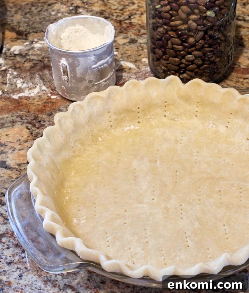 A pie shell ready to be prebaked.