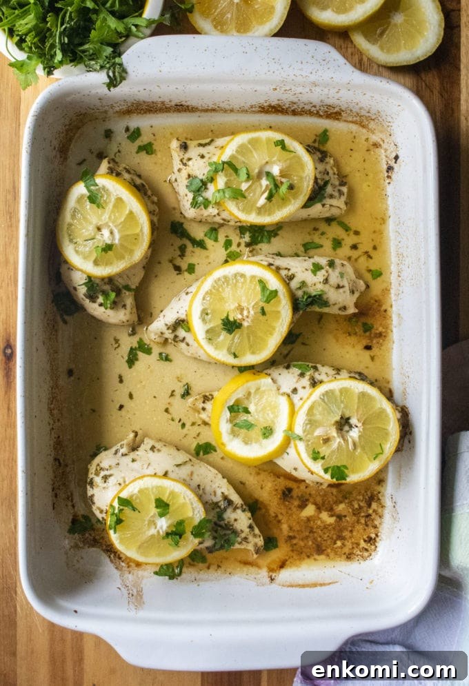 Juicy Baked Lemon-Herb Chicken Breasts for Weeknight Dinners 4 baked lemon chicken in a pan