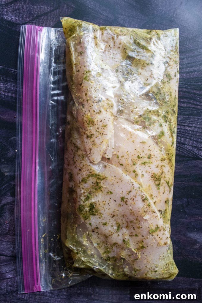 Juicy Baked Lemon-Herb Chicken Breasts for Weeknight Dinners 7 chicken marinating in a bag