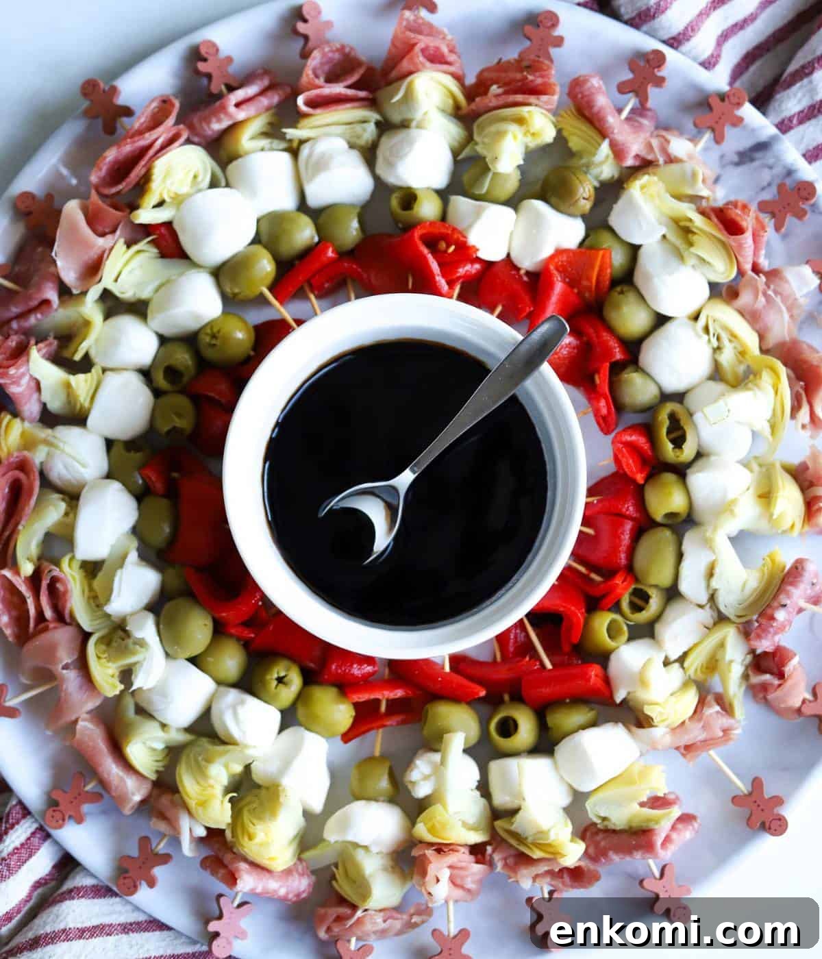 Charcuterie Skewers: Delicious Crowd‑Pleaser Appetizer Recipe 2 Charcuterie skewers on platter with balsamic glaze in bowl in center.