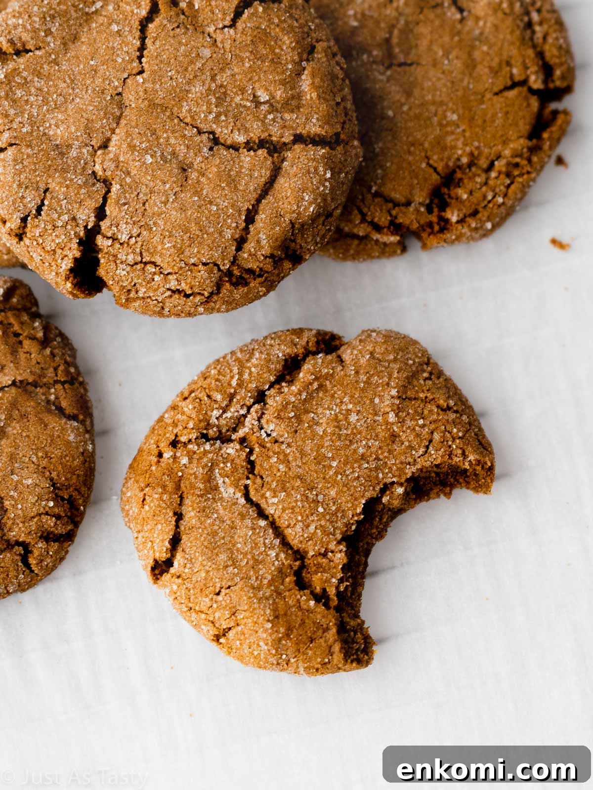 Close-up of a gingersnap cookie with a bite taken out. 