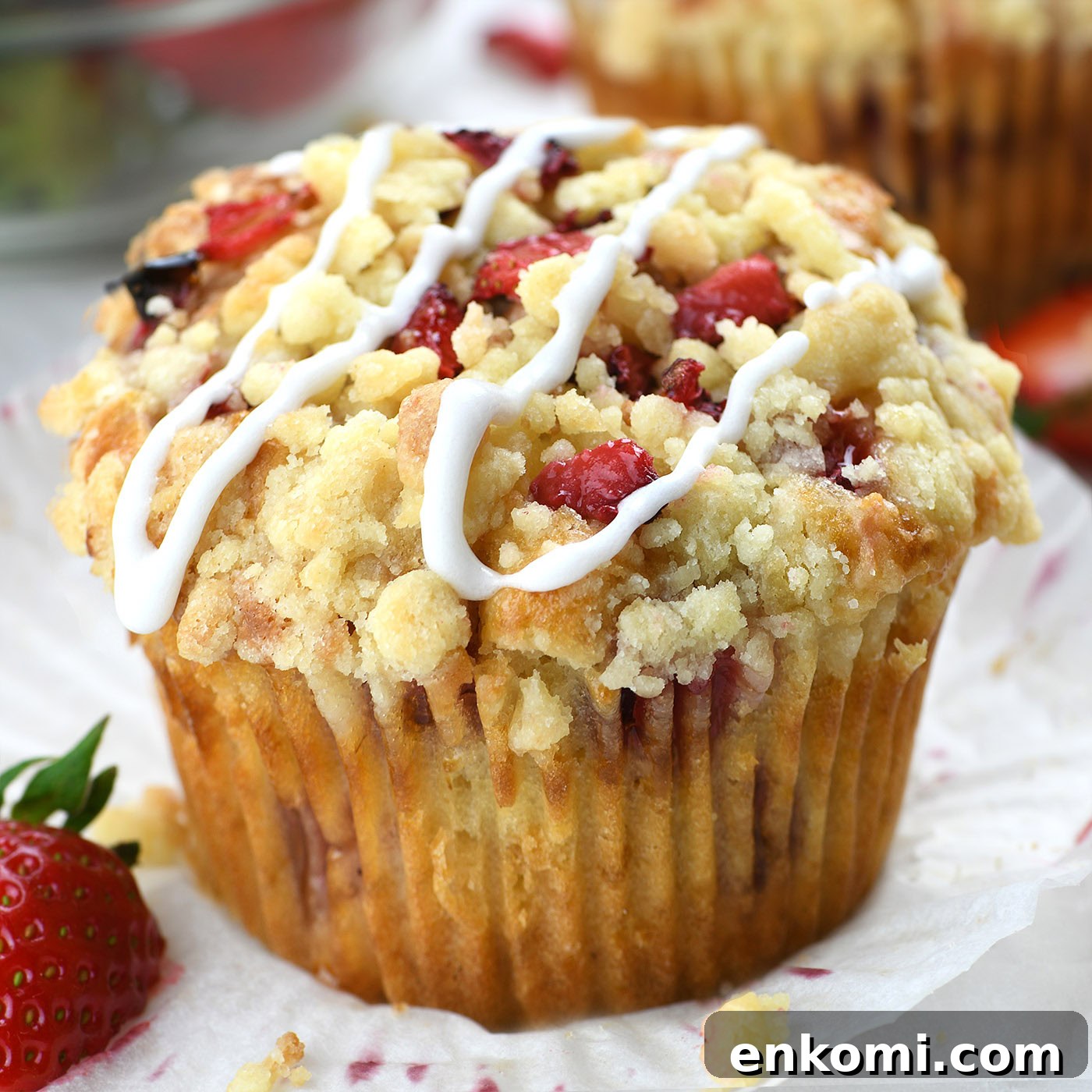 Strawberry Cream Cheese Muffins Recipe — Soft & Lemony 3 strawberry muffin with crumb topping and sweet glaze close up bakery style texture