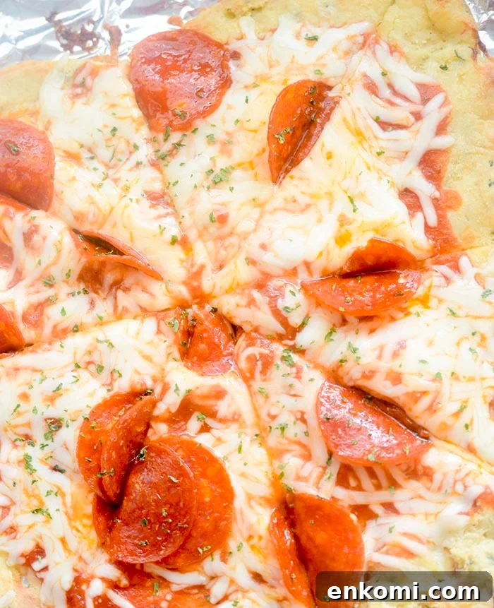 Fat head dough topped with pizza sauce, cheese and tomatoes.