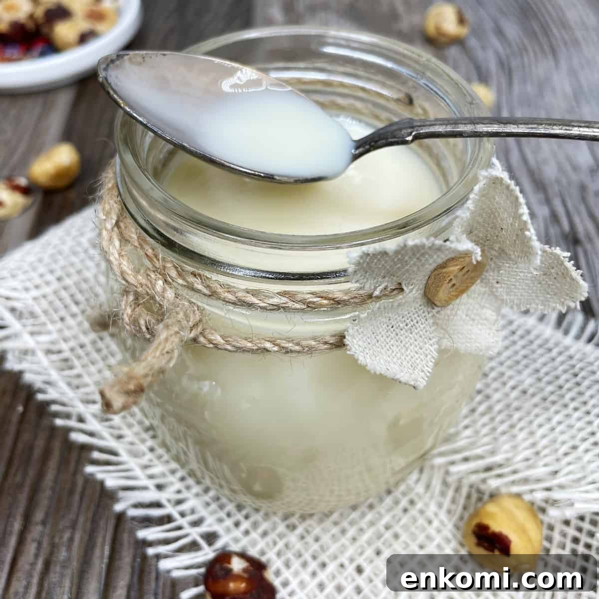 Homemade Condensed Milk Recipe for Rich, Creamy Results 2 Homemade condensed milk with a spoon in a jar