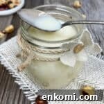 Homemade Condensed Milk Recipe for Rich, Creamy Results 11 Homemade condensed milk with a spoon in a jar.