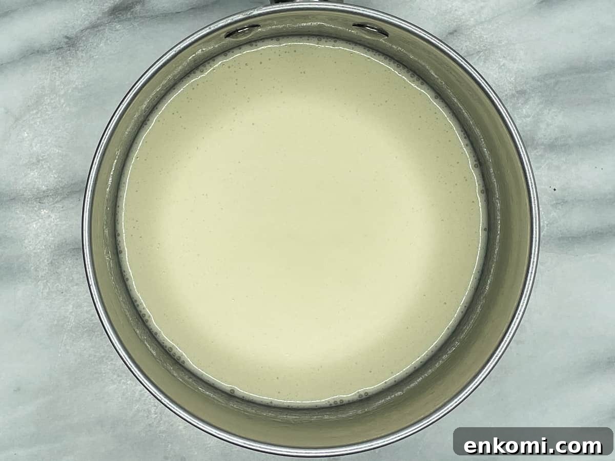 Homemade Condensed Milk Recipe for Rich, Creamy Results 5 Cooked condensed milk in a saucepan