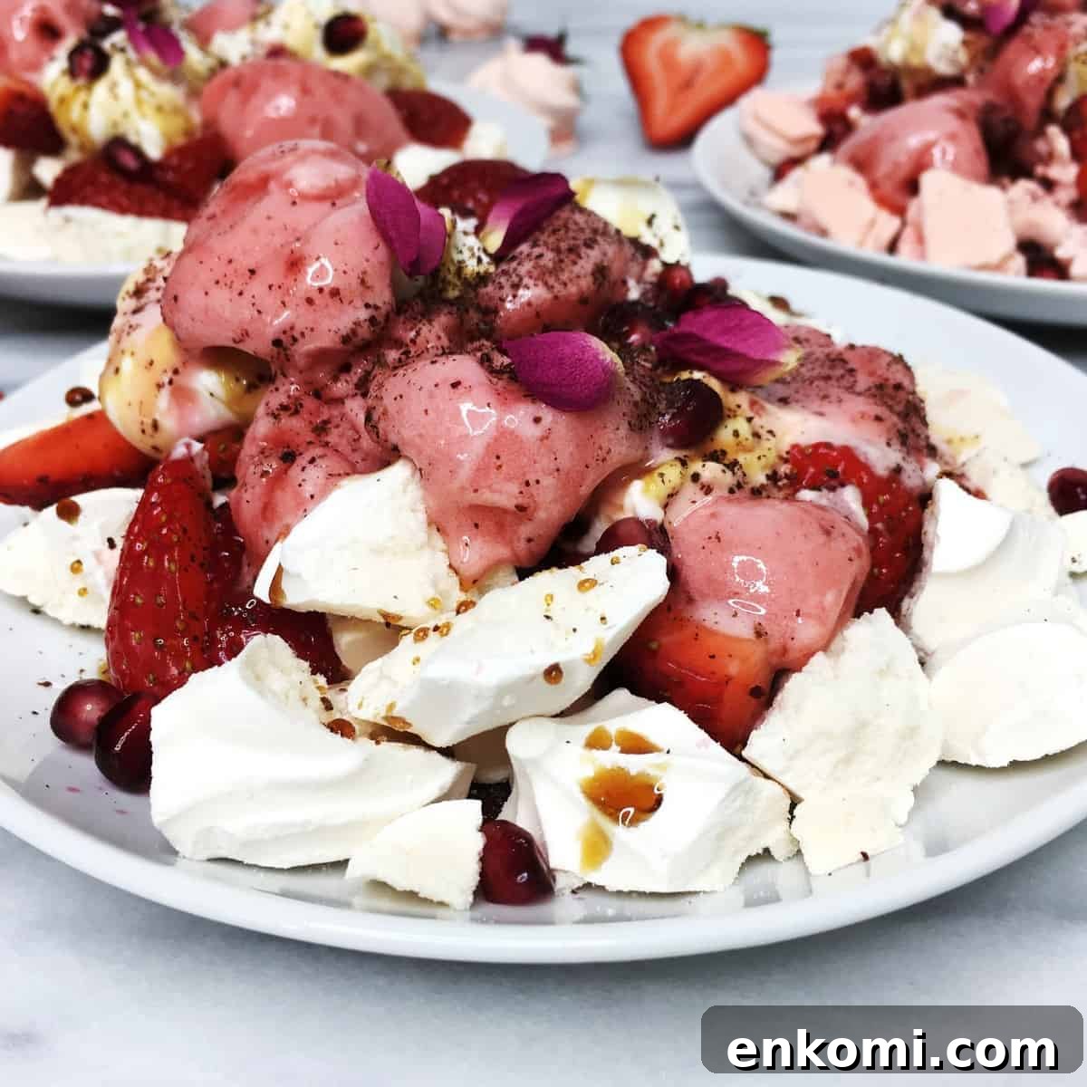 Eton mess: crushed meringues topped with strawberries, and cream served on the white plates.