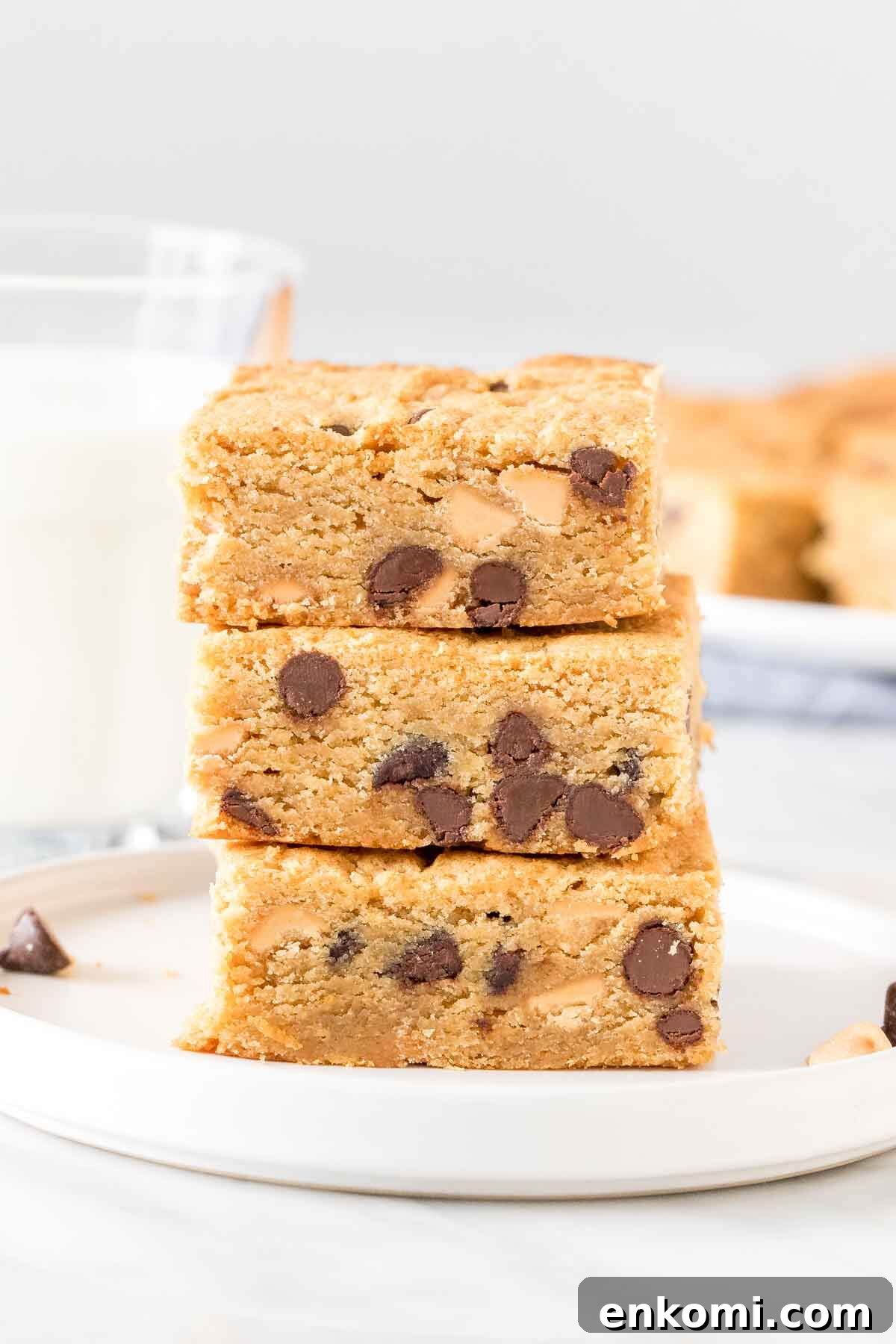 Stack of 3 peanut butter cookie bars with chocolate chips. 