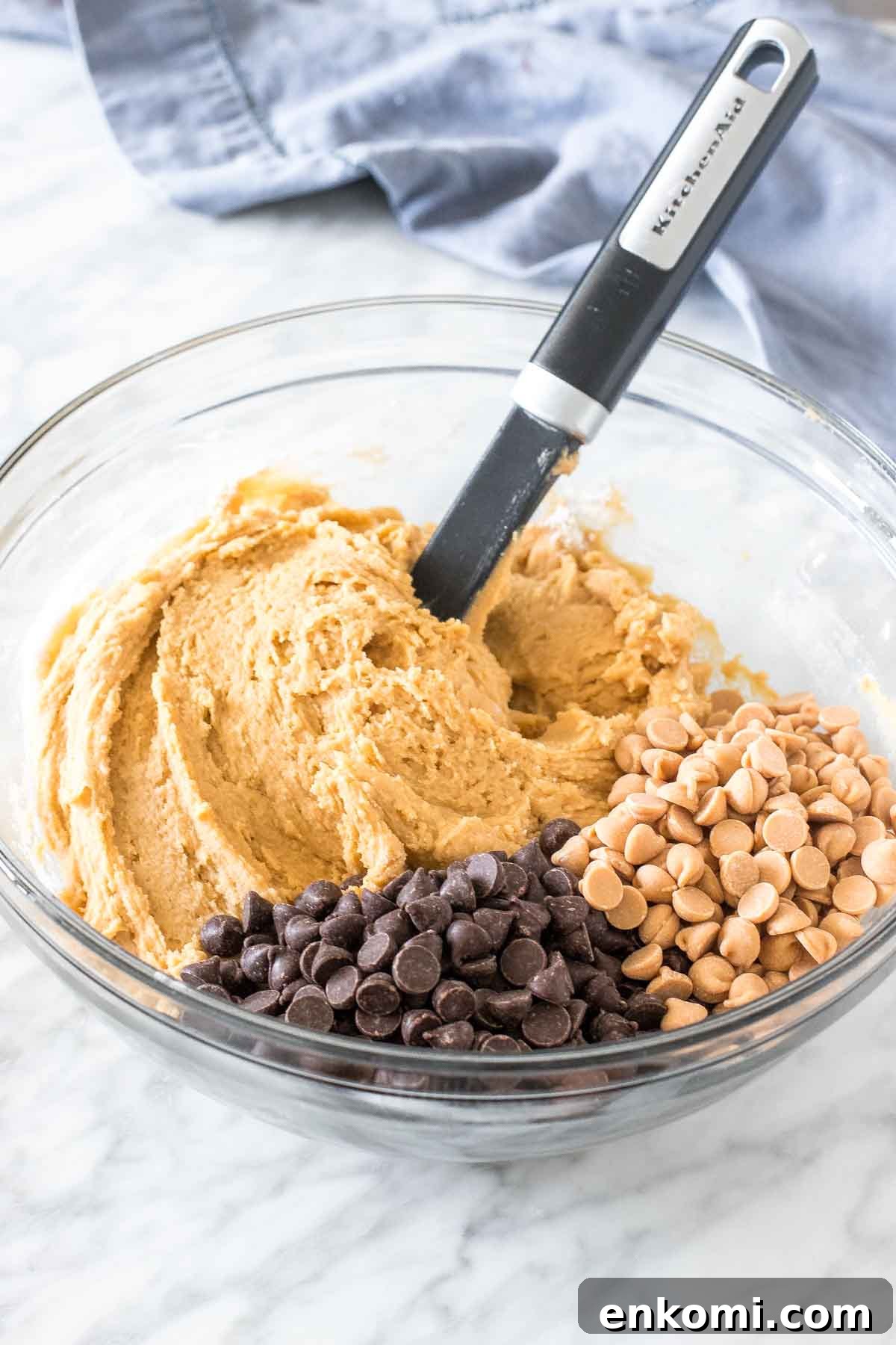 Bowl of cookie dough with chocolate chips and peanut butter chips. 