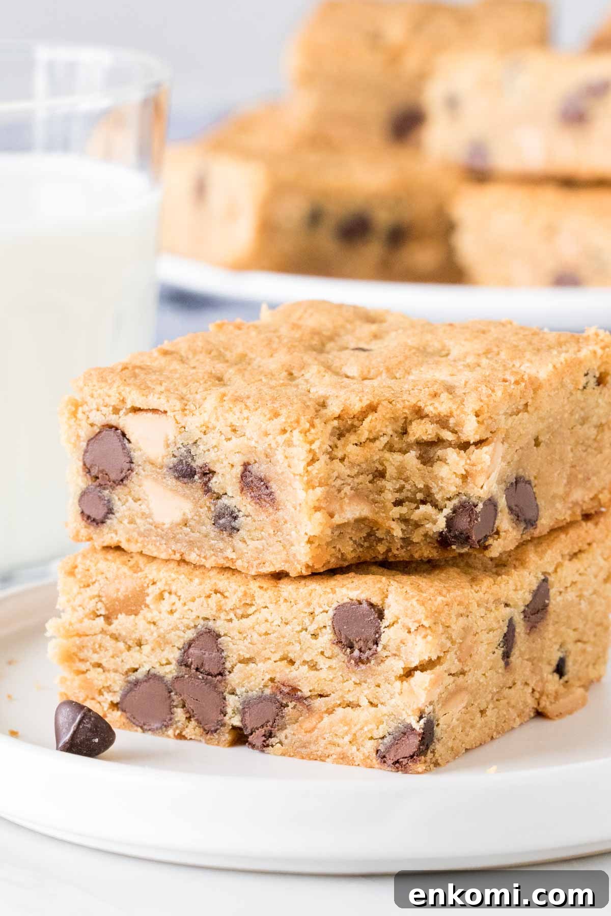 2 peanut butter cookie bars stacked, with a bite out of the top bar. 