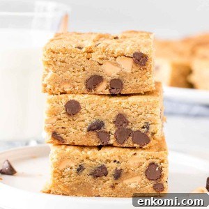 Stack of 3 peanut butter cookie bars with chocolate chips.