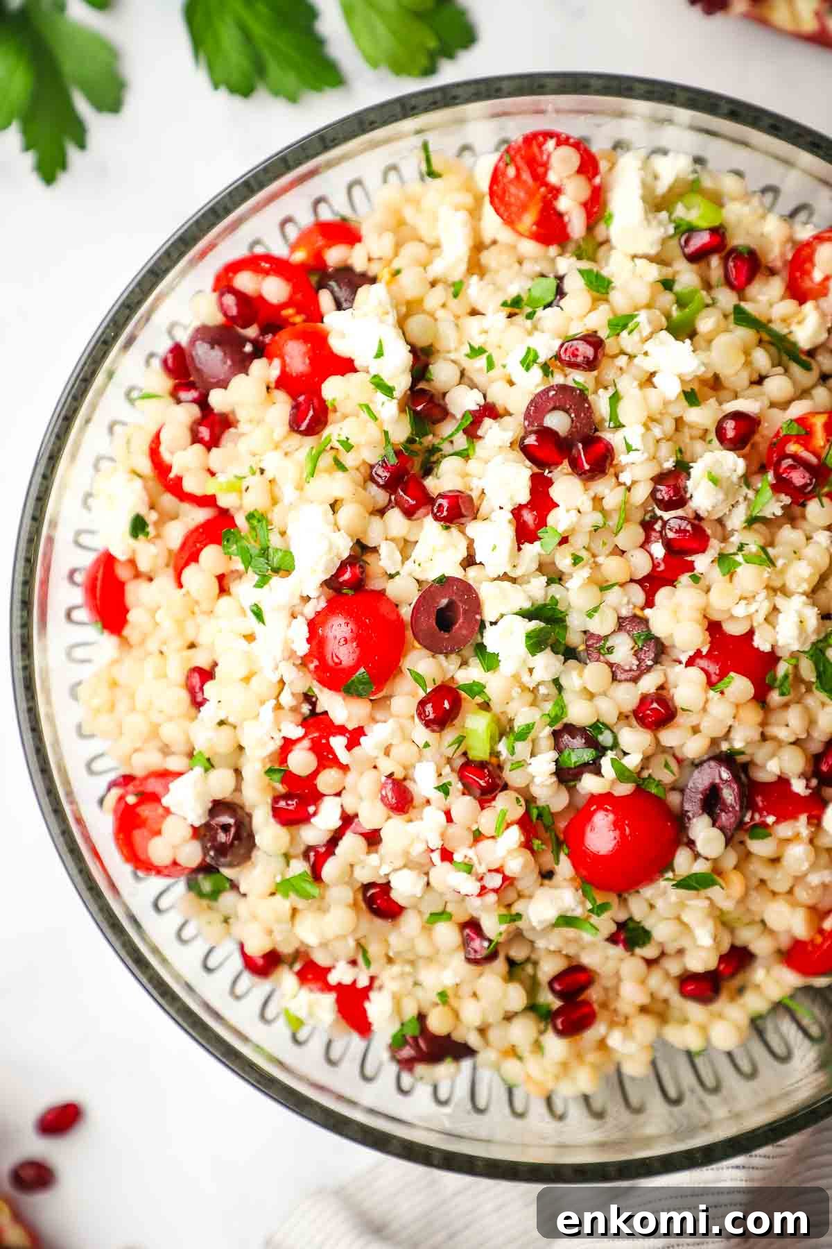 Mediterranean Pearl Couscous Salad with Fresh Herbs & Feta 4 Closeup of a large serving bowl of Mediterranean pearl couscous salad.