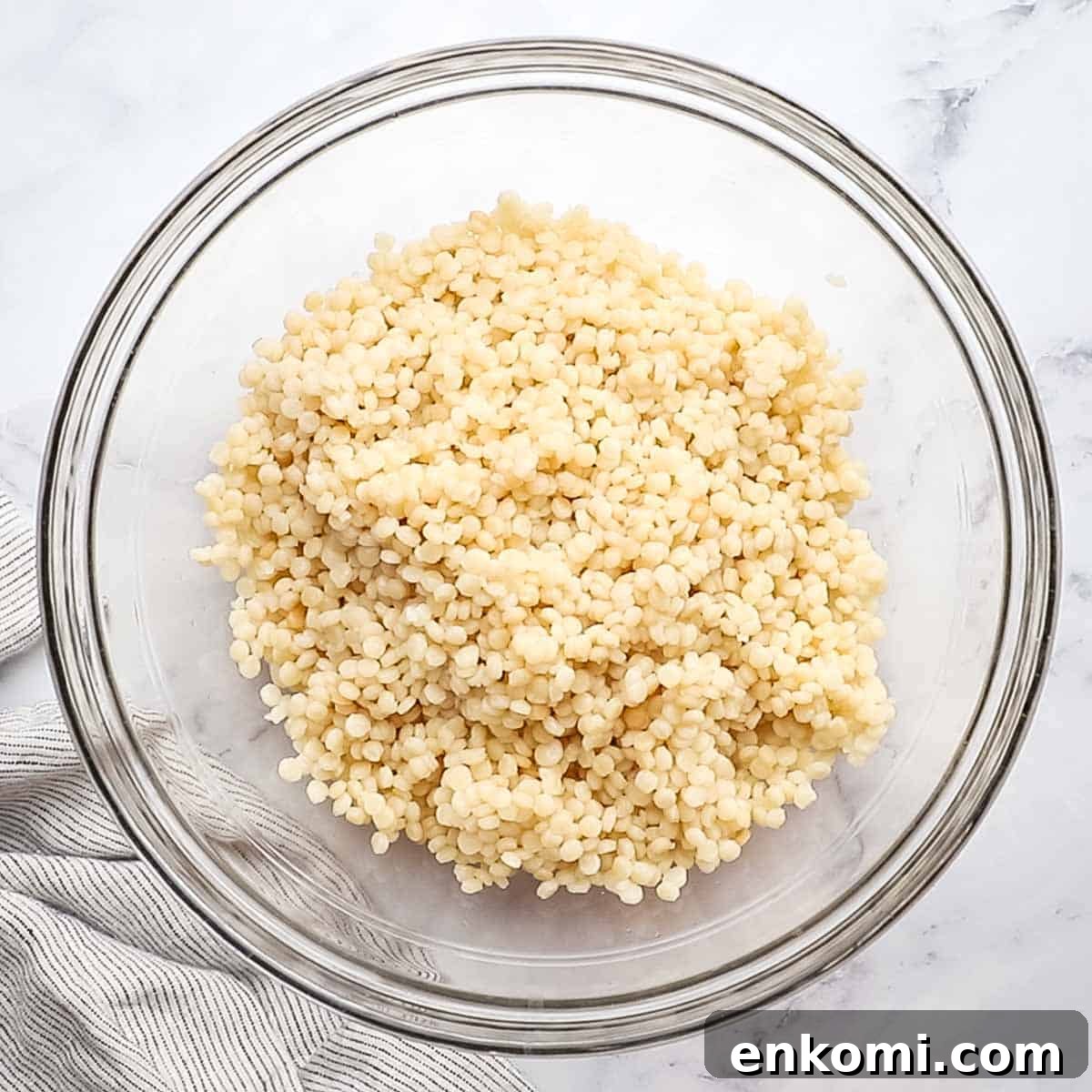 Mediterranean Pearl Couscous Salad with Fresh Herbs & Feta 8 Cooked Israeli couscous cooling in a large bowl.