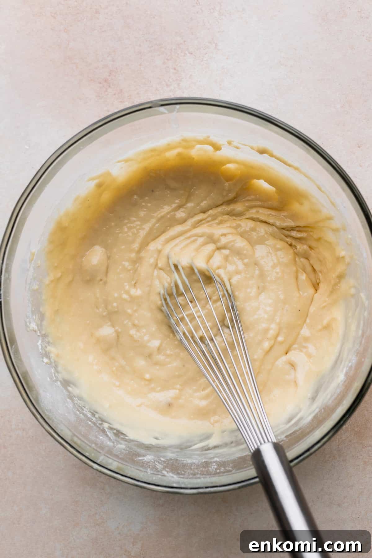 Donut batter in a glass bowl.
