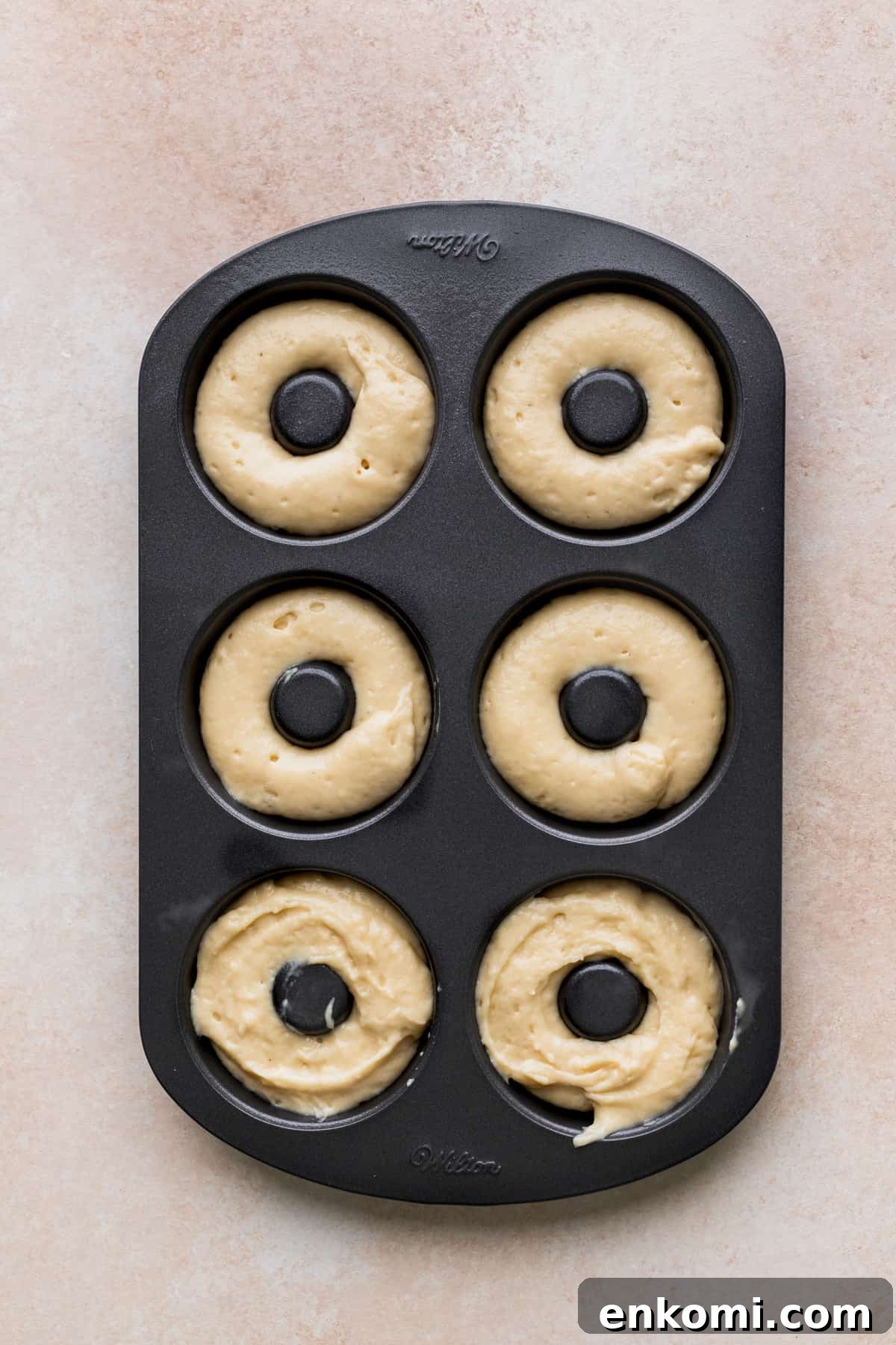 Donut cake batter in a donut pan.