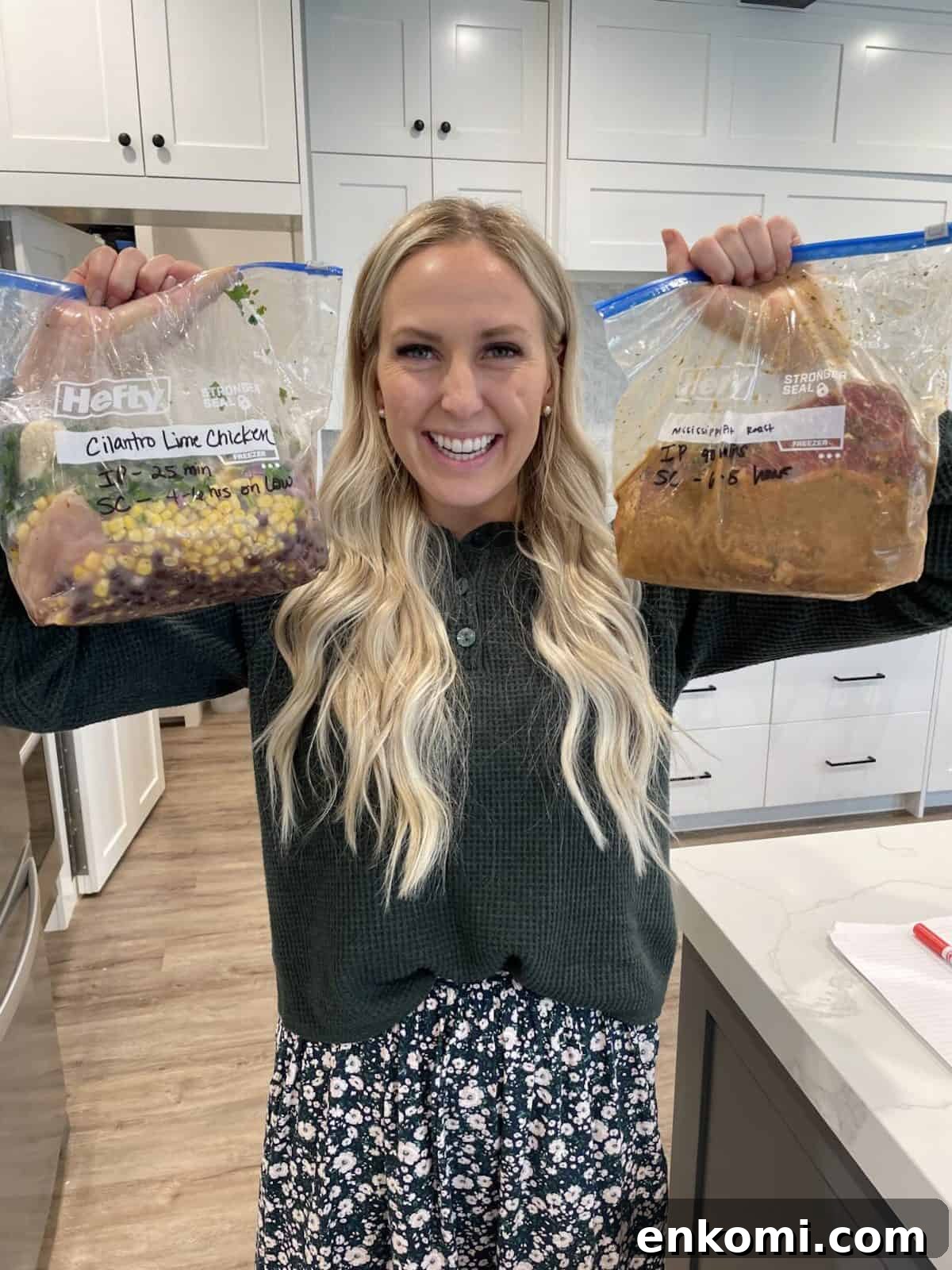 Meal Prep: How to Plan and Freeze Weekly Dinners for Busy Weeks 2 kendra holding her prepped freezer meals in the air