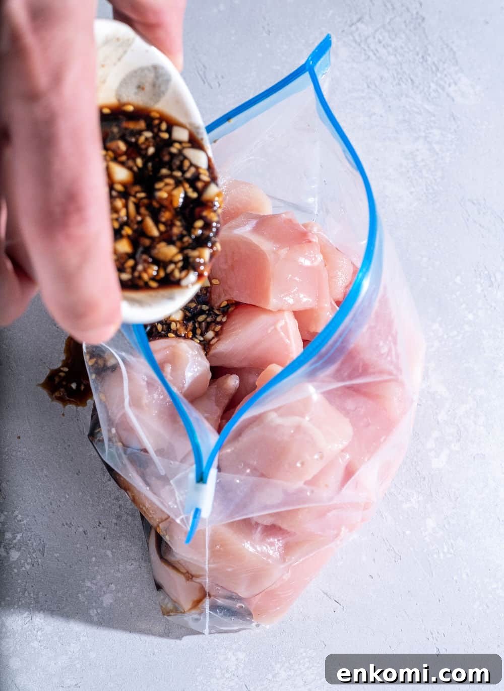 Meal Prep: How to Plan and Freeze Weekly Dinners for Busy Weeks 3 prepping a freezer meal with sauce and raw chicken