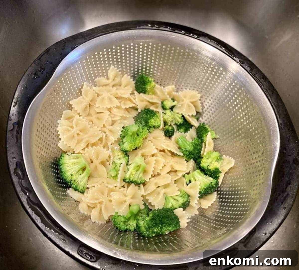 Draining noodles and broccoli in a colander