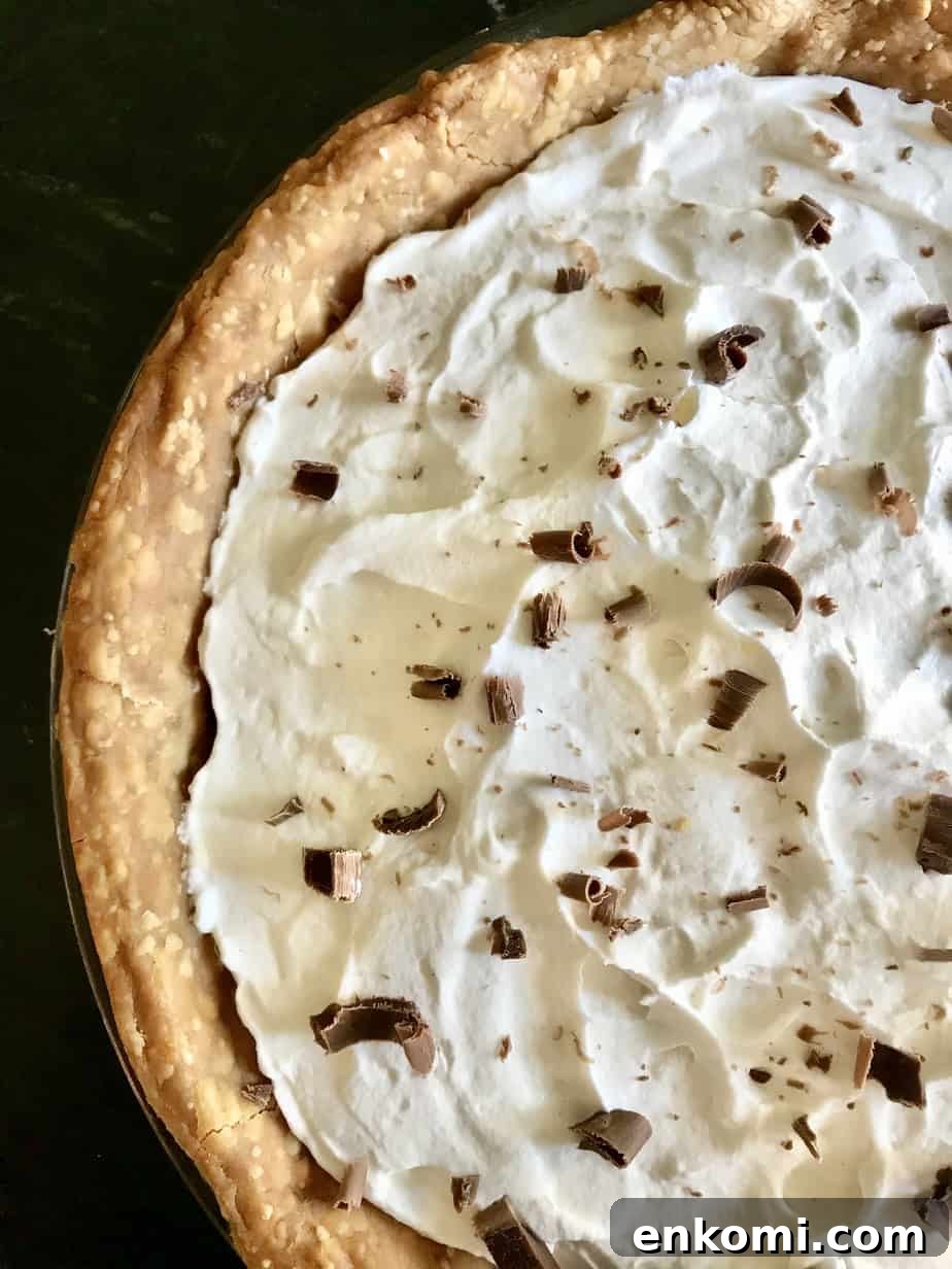 Old Fashioned Chocolate Pie topped with whipped cream and chocolate shavings