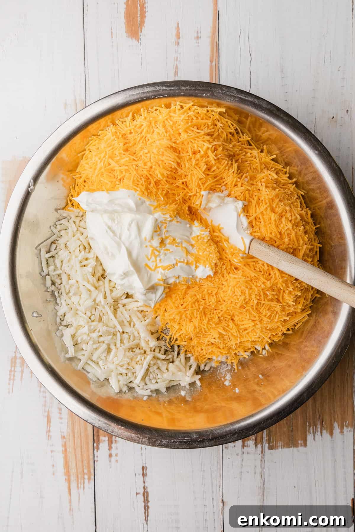 Crockpot Cheesy Hashbrown Casserole Recipe for Slow Cooker 4 Mixing the ingredients to make the recipe.